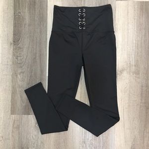 Black shiny leggings with lace up front detailing.